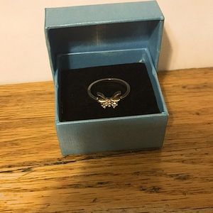 A gold butterfly ring
